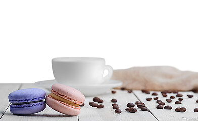 Image showing Two macaroons with cup coffee beans