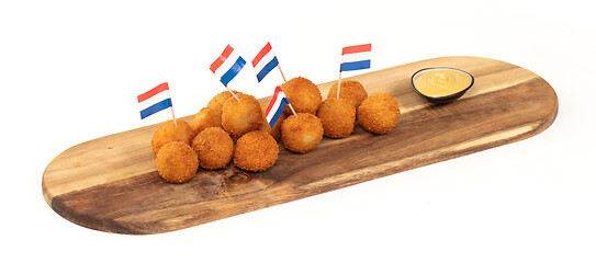 Image showing Dutch traditional snack bitterbal on a serving board, dutch flag