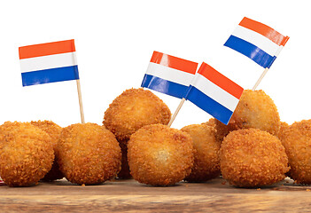 Image showing Dutch traditional snack bitterbal on a serving board, dutch flag