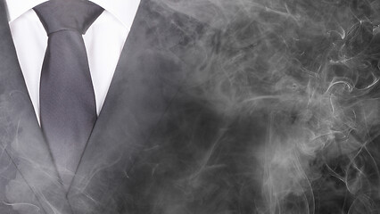 Image showing Man in a black suit, standing in smoke, close-up