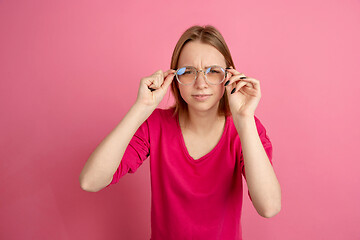 Image showing Caucasian young woman\'s monochrome portrait on pink studio background, emotinal and beautiful