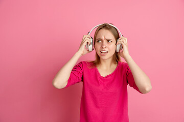 Image showing Caucasian young woman\'s monochrome portrait on pink studio background, emotinal and beautiful