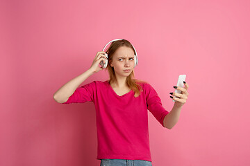 Image showing Caucasian young woman\'s monochrome portrait on pink studio background, emotinal and beautiful