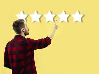 Image showing Man touching five star symbol to increase rating of company, app or service
