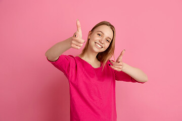 Image showing Caucasian young woman\'s monochrome portrait on pink studio background, emotinal and beautiful