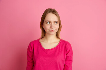 Image showing Caucasian young woman\'s monochrome portrait on pink studio background, emotinal and beautiful