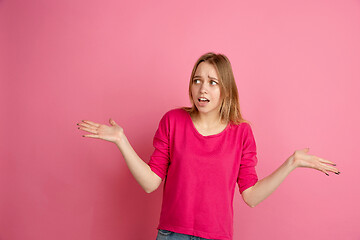 Image showing Caucasian young woman\'s monochrome portrait on pink studio background, emotinal and beautiful