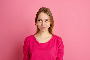 Image showing Caucasian young woman\'s monochrome portrait on pink studio background, emotinal and beautiful