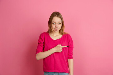 Image showing Caucasian young woman\'s monochrome portrait on pink studio background, emotinal and beautiful