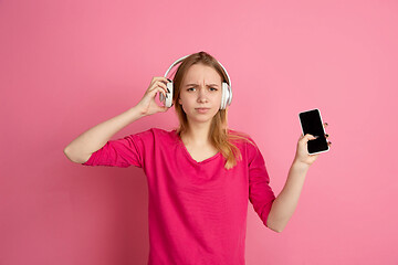 Image showing Caucasian young woman\'s monochrome portrait on pink studio background, emotinal and beautiful