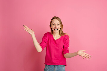 Image showing Caucasian young woman\'s monochrome portrait on pink studio background, emotinal and beautiful