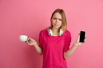 Image showing Caucasian young woman\'s monochrome portrait on pink studio background, emotinal and beautiful