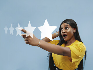 Image showing Woman touching five star symbol to increase rating of company, app or service