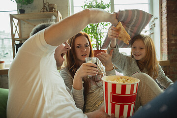 Image showing Family spending nice time together at home, looks happy and cheerful, watching TV