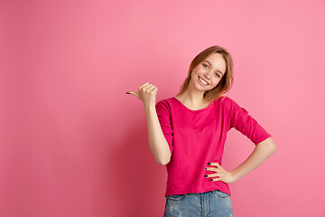 Image showing Caucasian young woman\'s monochrome portrait on pink studio background, emotinal and beautiful