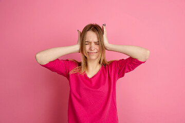 Image showing Caucasian young woman\'s monochrome portrait on pink studio background, emotinal and beautiful