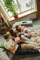 Image showing Family spending nice time together at home, looks happy and cheerful, watching TV