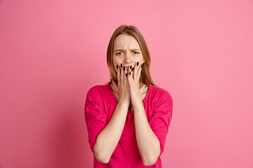 Image showing Caucasian young woman\'s monochrome portrait on pink studio background, emotinal and beautiful