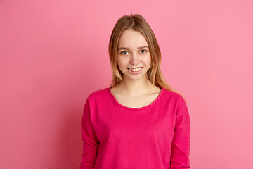 Image showing Caucasian young woman\'s monochrome portrait on pink studio background, emotinal and beautiful