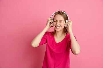 Image showing Caucasian young woman\'s monochrome portrait on pink studio background, emotinal and beautiful