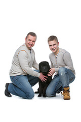 Image showing Father and son with dog