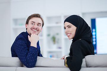 Image showing young muslim couple watching TV together