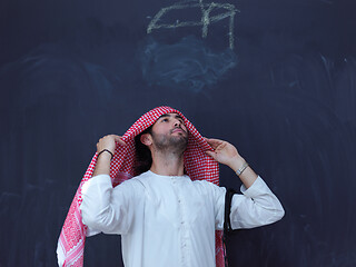 Image showing portrait of arabian man in front of black chalkboard