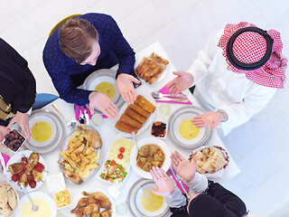 Image showing traditional muslim family praying before iftar dinner