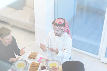 Image showing traditional muslim family praying before iftar dinner