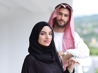 Image showing portrait of beautiful arabian couple standing on balcony