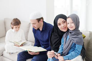 Image showing muslim family reading Quran and praying at home