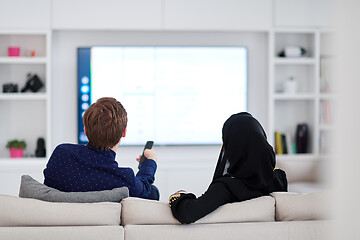 Image showing young muslim couple watching TV together