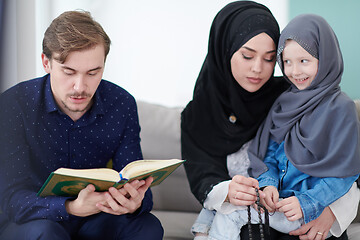 Image showing muslim family reading Quran and praying at home