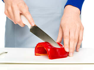 Image showing Cook is chopping bell pepper