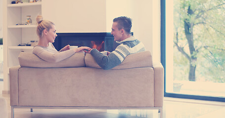 Image showing Young couple  in front of fireplace