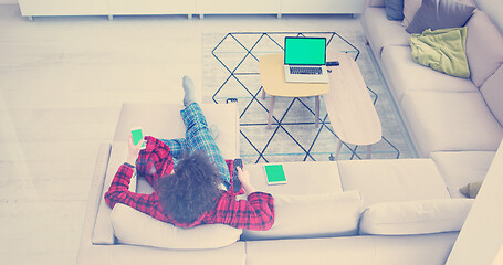 Image showing Young couple on the sofa watching television