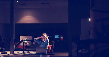 Image showing businessman relaxing at the desk