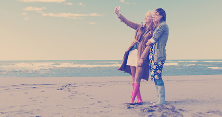 Image showing Girls having time and taking selfie on a beach