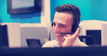 Image showing male call centre operator doing his job