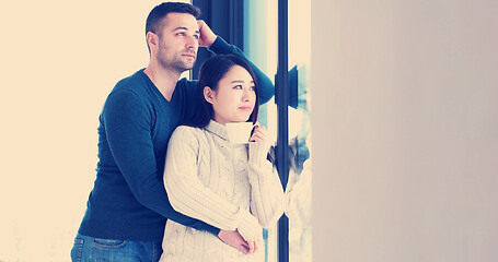 Image showing multiethnic couple relaxing at modern home indoors