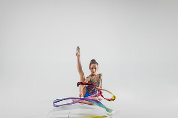 Image showing The portrait of beautiful young brunette woman gymnast training calilisthenics exercise with ribbon