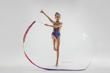 Image showing The portrait of beautiful young brunette woman gymnast training calilisthenics exercise with ribbon