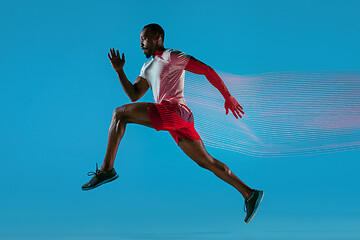 Image showing Full length portrait of active young muscular running man,