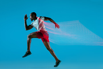 Image showing Full length portrait of active young muscular running man,