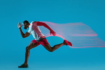 Image showing Full length portrait of active young muscular running man,
