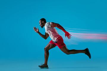 Image showing Full length portrait of active young muscular running man,