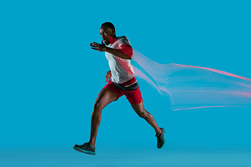 Image showing Full length portrait of active young muscular running man,