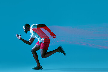 Image showing Full length portrait of active young muscular running man,