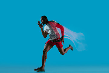 Image showing Full length portrait of active young muscular running man,