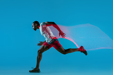 Image showing Full length portrait of active young muscular running man,